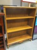 Three Shelf Oak Bookcase with Adjustable Shelves and Decorative Bottom and Legs.