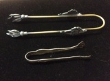 2 ice cube tongs, 1 is brass & pewter and 1 is sterling