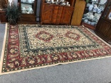 Modern dining room floral design rug in muted red gold and green - nice cond.