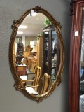 Ornate gilded flower motif mirror with antique inspired look