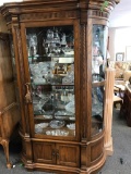 Antique curved front lighted curio cabinet w/ glass shelves and door