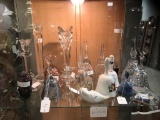 Shelf full of art glass, porcelain/ crystal bells & more