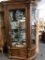 Antique curved front lighted curio cabinet w/ glass shelves and door