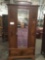 Antique beveled mirrored front armoire with vibrant burled wood front - good cond