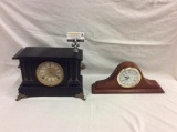Two mantle clocks; 1 antique dark w/ wood lion head embellishments and 1 sunbeam see pics