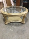 Modern glass top art nouveau inspired coffee table w/ cream color and ornate design