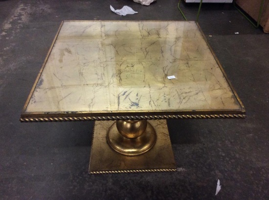 Modern burnished gold pillar base dining table with glass top and ornate "marbled" look