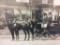 Black and white stagecoach photograph in frame