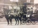 Black and white stagecoach photograph in frame