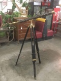 Antique brass and studded telescope on tripod