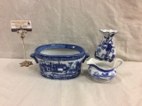 Selection of Asian inspired blue and white transfer ware porcelain pieces with traditional scenes