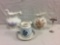 Selection of vintage porcelain floral themed pitchers incl. an ornate Laughlin pitcher