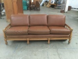 Vintage leather mid century Thomasville couch with studded arm detail and carved sides