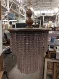 Outstanding vintage wood and bead chandelier with milk glass center shade