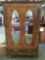 Stunning antique double armoire with oval beveled mirror and spalted maple inlay w/ ornate carving