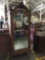 Antique continental single armoire with large beveled glass door, elaborate carving and classic