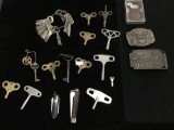 Collection of antique keys, belt buckles, and knives from estate