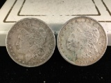 2 silver Morgan dollars, 1882-S and a 1921-S