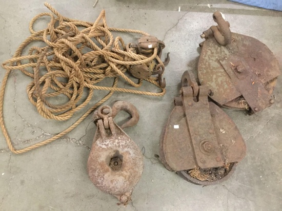 Collection of 3 antique large rusted steel pulleys and rope with wood pulleys