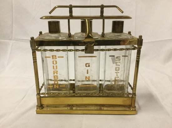 Antique brass locking liquor bottle carry rack with three bottles; marked Bourbon, Gin and Scotch