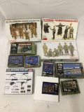 11 model kits, 1/35 scale. Characters, guns, supplies, ammo, radios, barrels, etc. see pics