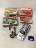 2 RC Cars, and 4 Car model kits. As is - see pics