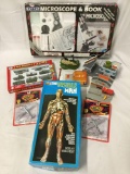 Lot of vintage toys. Revell the visible man, cars, sets, and a microscope kit.