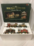 The Holiday Express Animated Train Set in original box. Includes engine, 3 Cars, tracks, and remote.