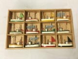 Small wooden shadow box with 12 wood boat models 12.5 x 8 inches.