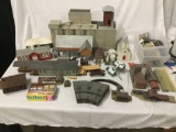 Large lot of assorted model train buildings, various scales. Tallest is 12 inches tall. See pics
