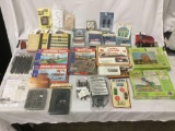 Large lot of model train accessories. Mostly new, some used, lights, buildings, gates, etc. see pics