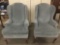 Pair of matching blue wingback arm chairs - missing on arm cover