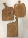 3 hand carved wooden cutting boards with carved reliefs