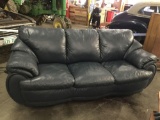 Navy blue faux leather couch with rounded edge modern design