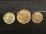 A silver 1923-P peace dollar and 2 1964 Kennedy half dollars