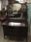 Antique curved front 3 drawer vanity dresser with large mirror, original handles and mahogany stain