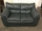 Green leather loveseat in good cond- matches 329