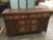 Antique burl front wood server sideboard with brass fixtures and carved door detail