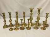 13 brass candle holders - some pairs some singles