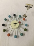 Decorative wall battery operated clock , approx 14 x 3 inches. As is.