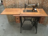 Antique Singer cast sewing machine station in oak table, model #16249115