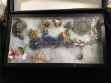 Collection of beautiful vintage estate brooches in a display case