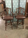 Pair of 2 modern swivel bar stools with leather seats and antique style design