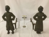 Pair of antique cast iron fireplace andirons with man and women figure design
