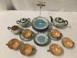 21 mid century luster ware Japanese tea set with orange/amber cup and blue/cream design