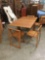 Compact vintage drop leaf table with 4 chairs that fit inside the table base