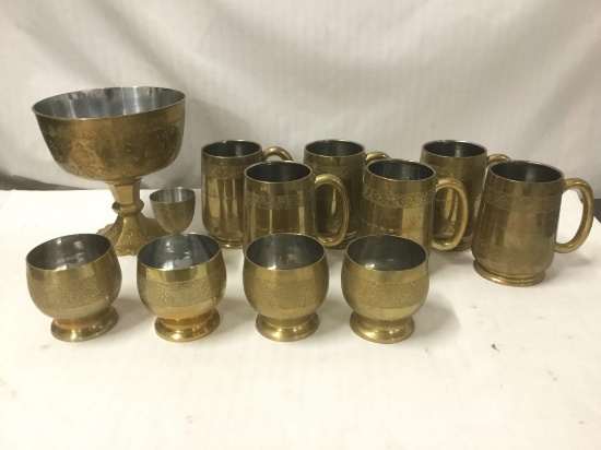 Selection of 12 etched brass mugs, tumblers, and chalice/elevated bowl