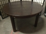 Vintage round coffee table with mahogany stain and middle leaf