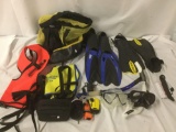 Lot of snorkeling equipment with flippers, masks, vests, Fuji Film XP underwater digital camera