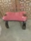 Small red cushioned top vintage camel stool with stud detail